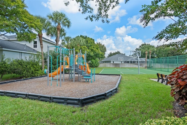 view of play area featuring basketball hoop and a yard