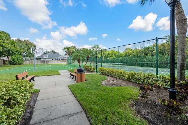 view of community featuring basketball court, a lawn, and tennis court