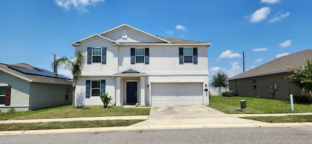 view of front of house with a garage and a front lawn