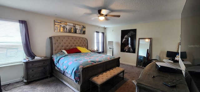 bedroom with ceiling fan, a textured ceiling, and carpet