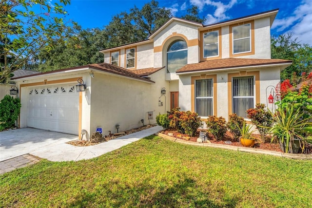 mediterranean / spanish house featuring a front yard, concrete driveway, stucco siding, and an attached garage