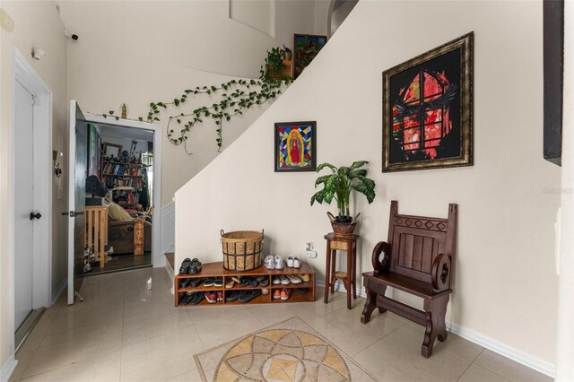 living area with baseboards and tile patterned flooring