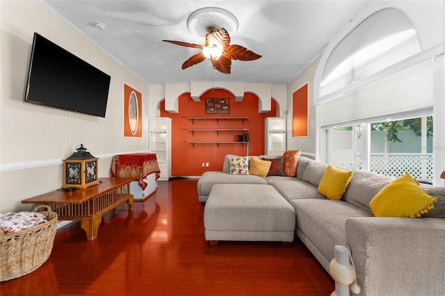 living room with wood finished floors and a ceiling fan