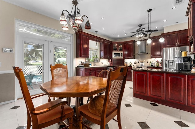 dining room with light tile patterned flooring, ceiling fan with notable chandelier, visible vents, and recessed lighting