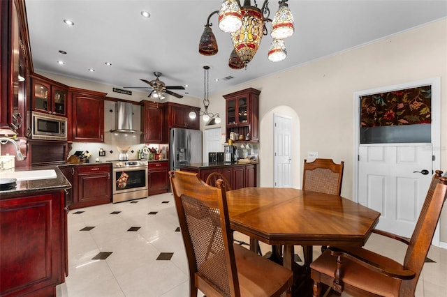 dining space featuring ceiling fan, crown molding, light tile patterned floors, and sink