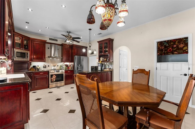 dining space featuring light tile patterned floors, arched walkways, recessed lighting, and a ceiling fan