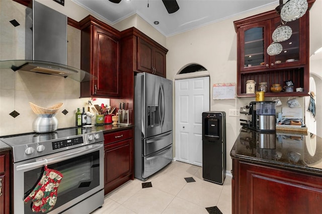 kitchen with wall chimney range hood, appliances with stainless steel finishes, light tile patterned floors, ornamental molding, and ceiling fan