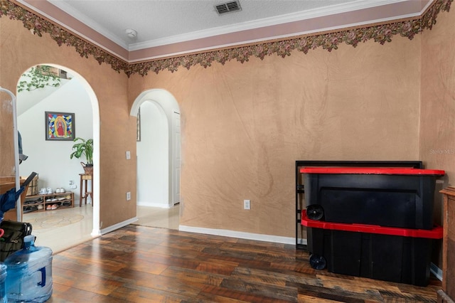 living room with a textured ceiling, crown molding, and dark hardwood / wood-style flooring