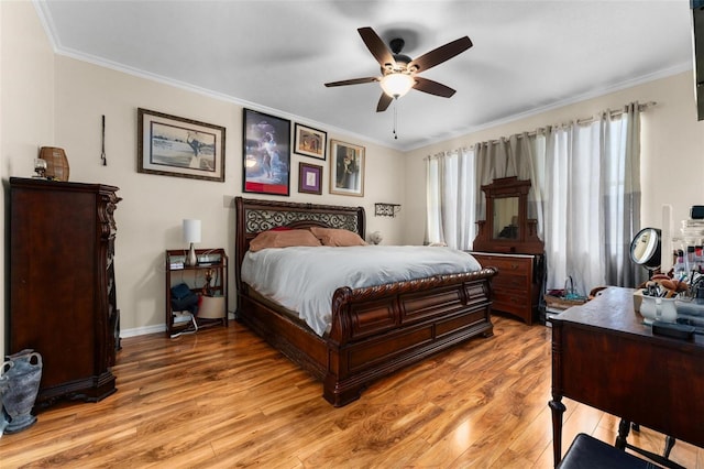bedroom with a ceiling fan, ornamental molding, baseboards, and light wood-type flooring