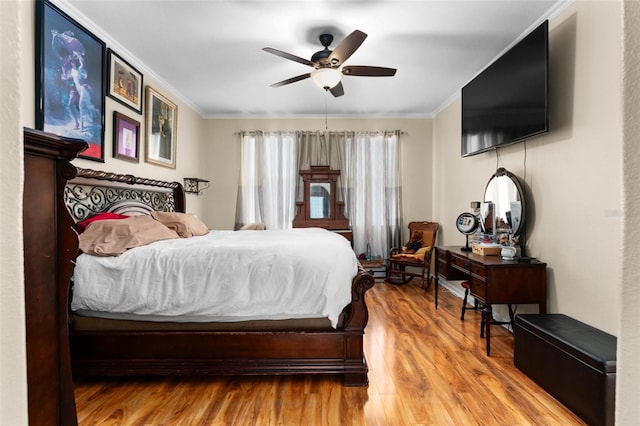 bedroom with ceiling fan, hardwood / wood-style flooring, and crown molding