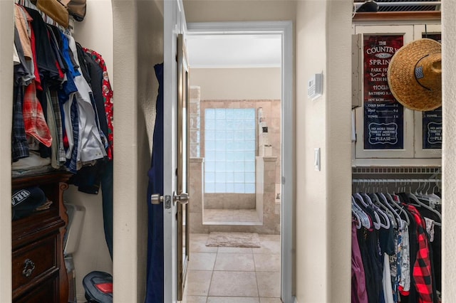 spacious closet featuring light tile patterned floors