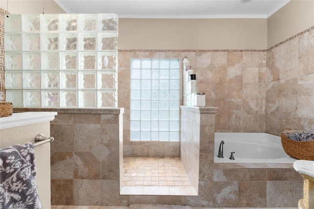 bathroom with ornamental molding, tile walls, a garden tub, and a walk in shower