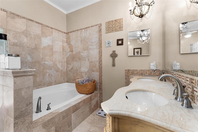 bathroom with tiled bath, crown molding, and a sink