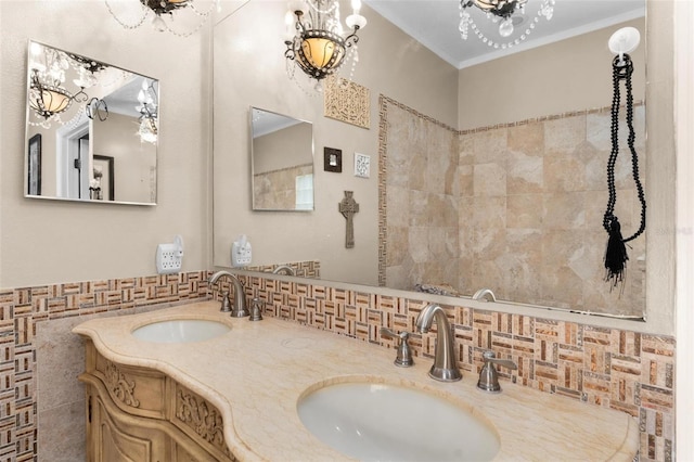 bathroom featuring a notable chandelier, tile walls, ornamental molding, and vanity