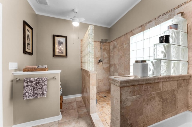 bathroom featuring ceiling fan, tile patterned floors, crown molding, and tiled shower