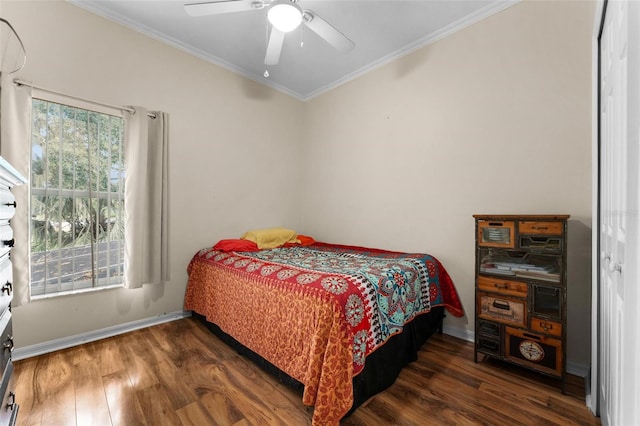 bedroom featuring ceiling fan, ornamental molding, and dark wood-type flooring