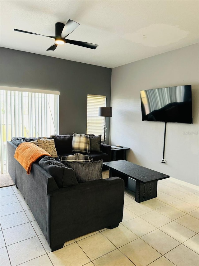 living room featuring ceiling fan and light tile patterned floors