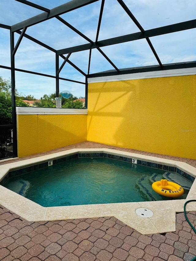 view of swimming pool with a lanai