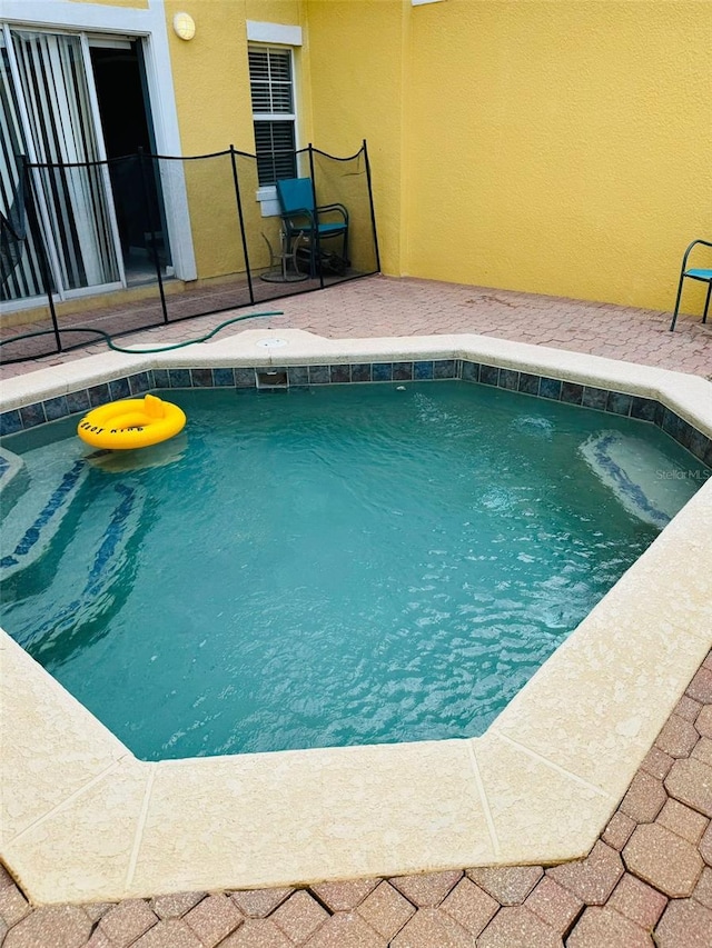 view of swimming pool with a patio area