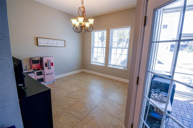 interior space with a chandelier and light tile patterned flooring