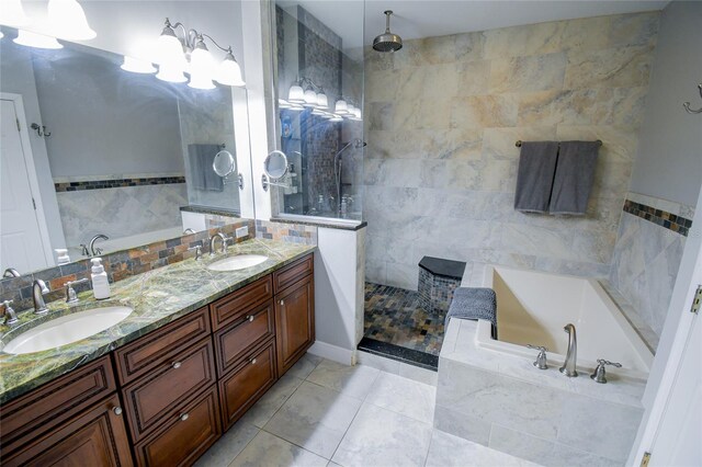 bathroom featuring tile walls, tile patterned flooring, vanity, and separate shower and tub