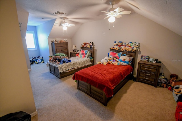 carpeted bedroom with a textured ceiling, vaulted ceiling, and ceiling fan