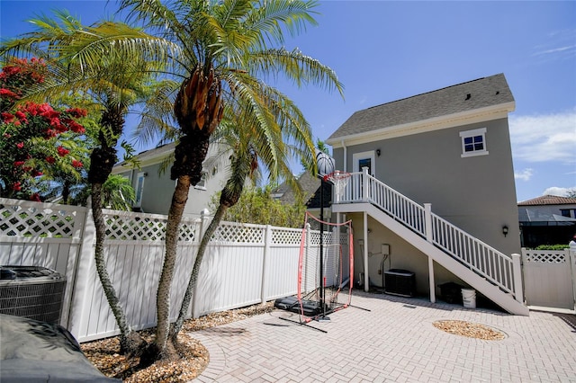 view of front of property featuring a patio and central AC