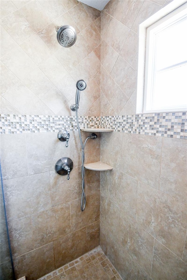 bathroom with tiled shower