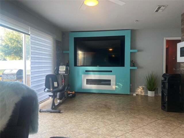 tiled living area with visible vents and a ceiling fan