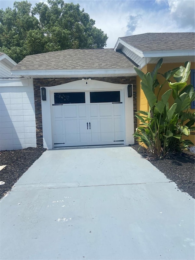 garage with concrete driveway