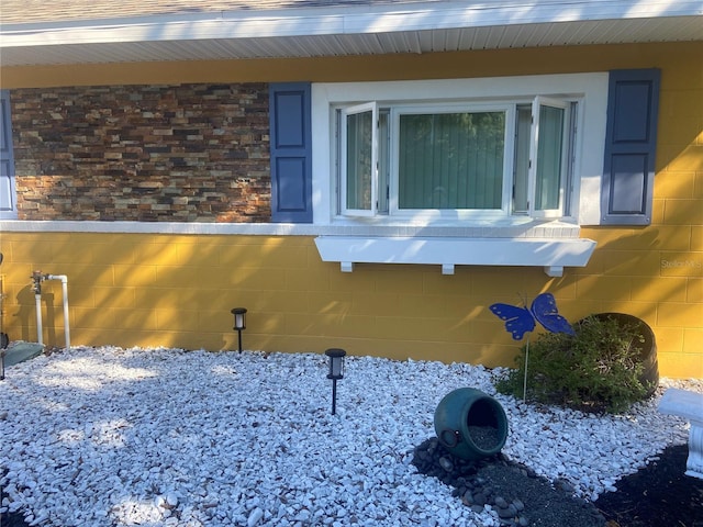 view of side of property featuring concrete block siding