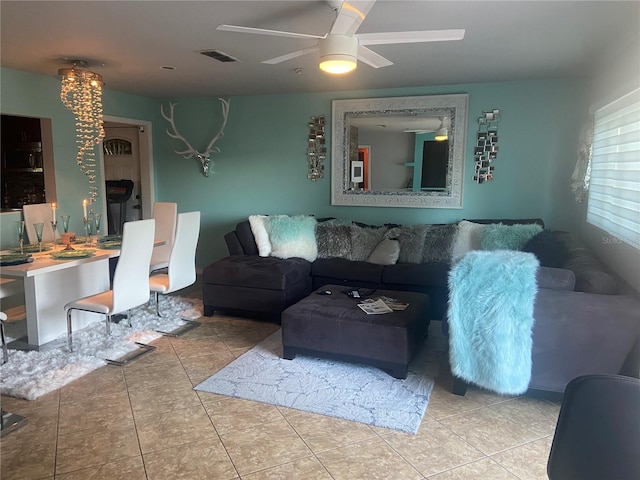 tiled living room with ceiling fan and visible vents