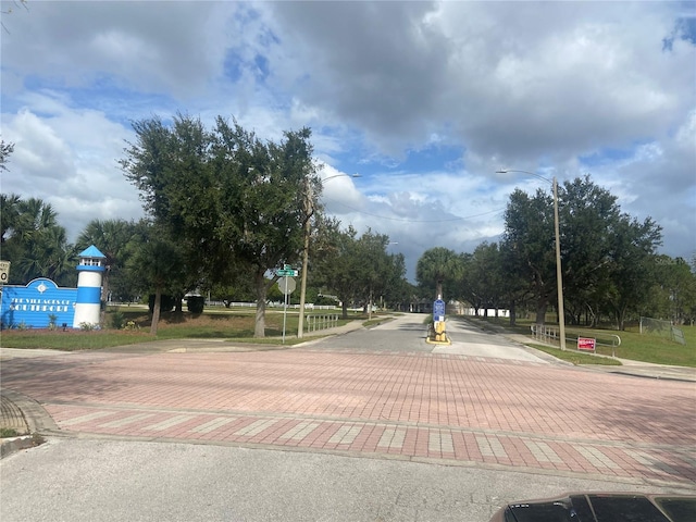 view of street with curbs, street lighting, and traffic signs