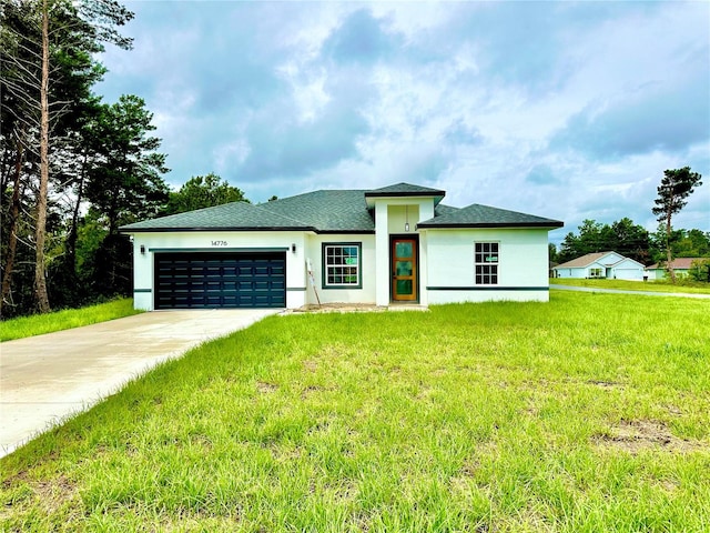 view of front of property featuring a front yard and a garage