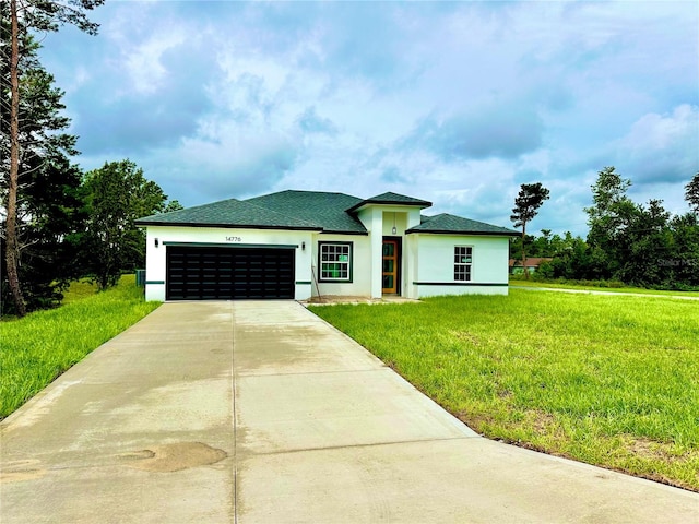 view of front of house with a front yard and a garage