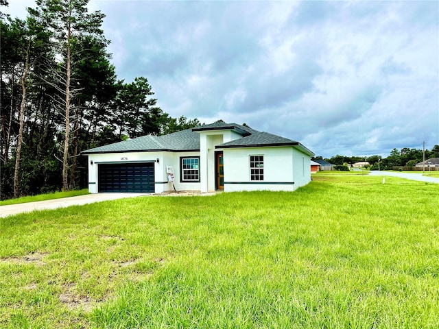 view of front of property featuring a garage and a front lawn