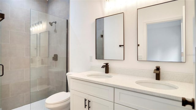 bathroom featuring walk in shower, vanity, and toilet