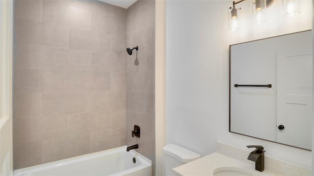 full bathroom featuring vanity, tiled shower / bath, and toilet