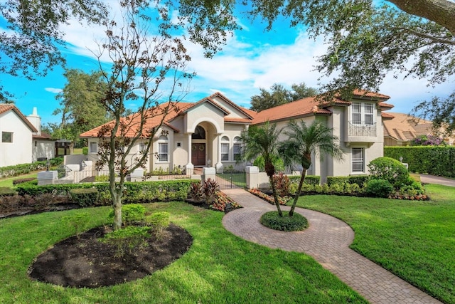 mediterranean / spanish-style house featuring a front yard