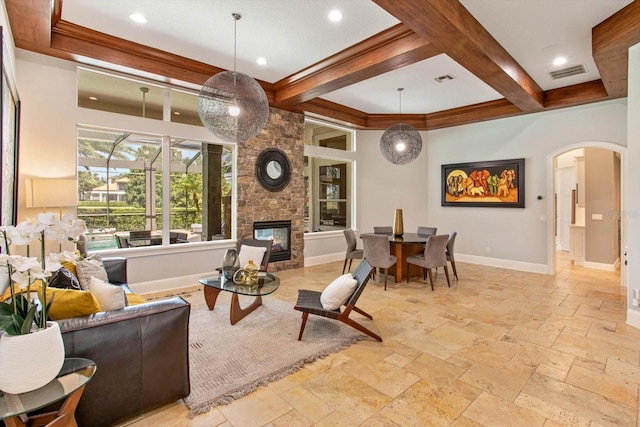 living room with coffered ceiling, beamed ceiling, and a fireplace