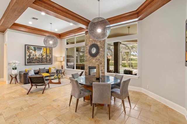 dining room with beamed ceiling, a fireplace, and crown molding