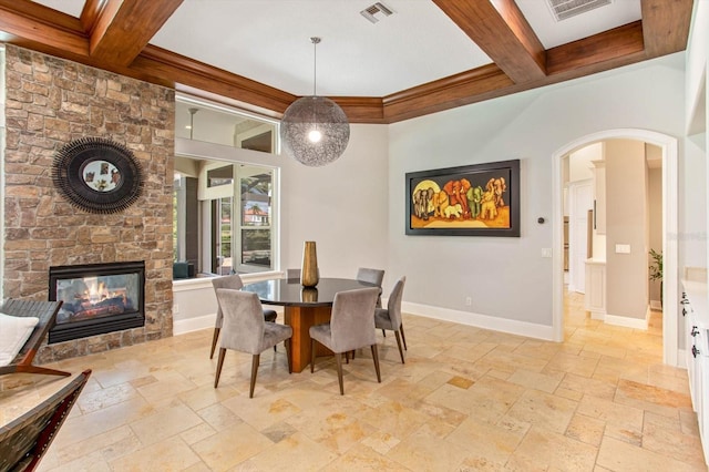 dining room with coffered ceiling, a fireplace, and beam ceiling