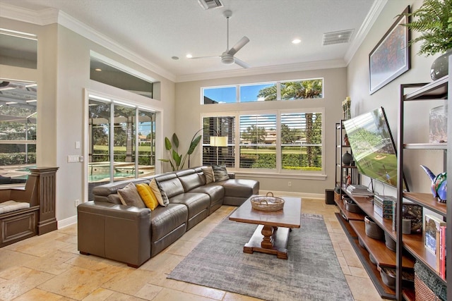 living room with ceiling fan, a textured ceiling, crown molding, and a towering ceiling