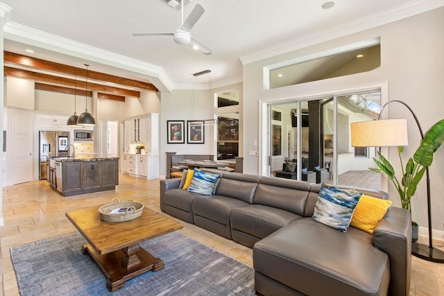 living room featuring ornamental molding, beam ceiling, and ceiling fan