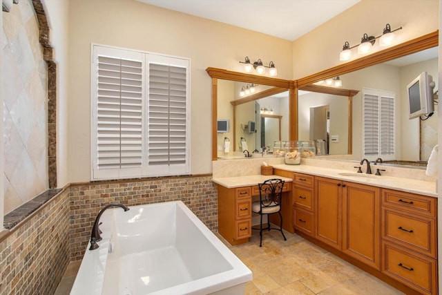 bathroom with tile walls, vanity, and a bathtub