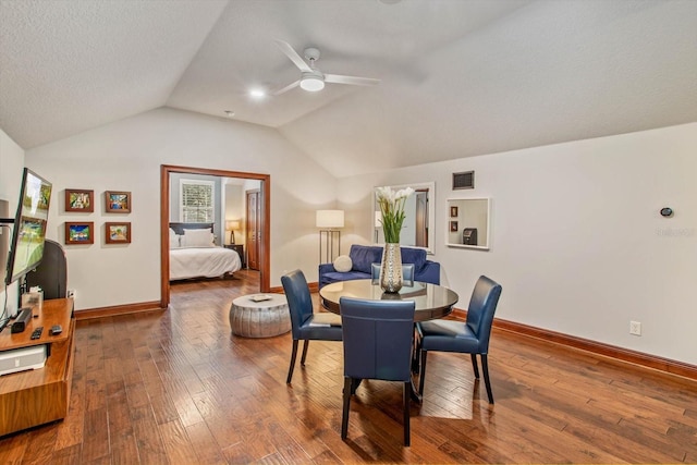 dining room with a textured ceiling, lofted ceiling, ceiling fan, and hardwood / wood-style flooring