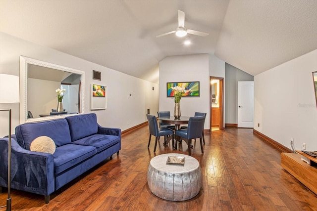 living room with ceiling fan, dark hardwood / wood-style floors, and vaulted ceiling