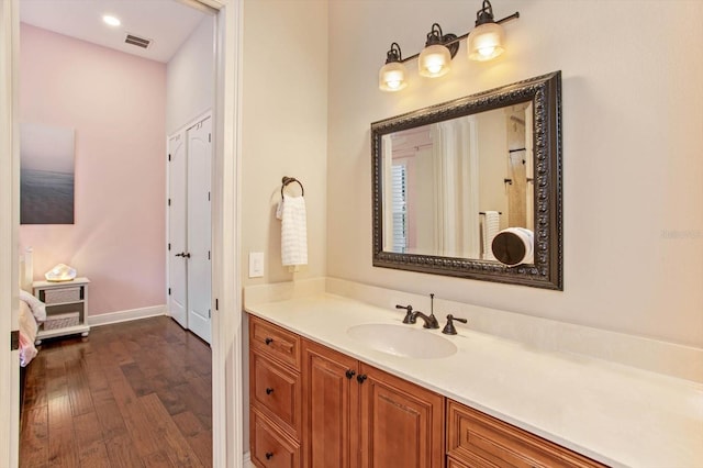 bathroom featuring vanity and hardwood / wood-style floors