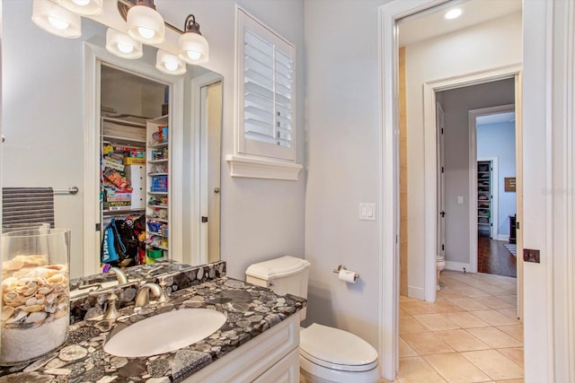 bathroom featuring tile patterned flooring, vanity, and toilet