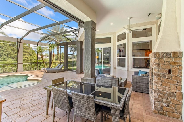 view of patio / terrace featuring glass enclosure, ceiling fan, and an outdoor hangout area